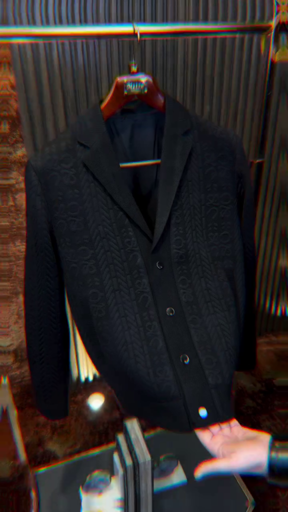 black single-breasted casual blazer with a textured pattern.